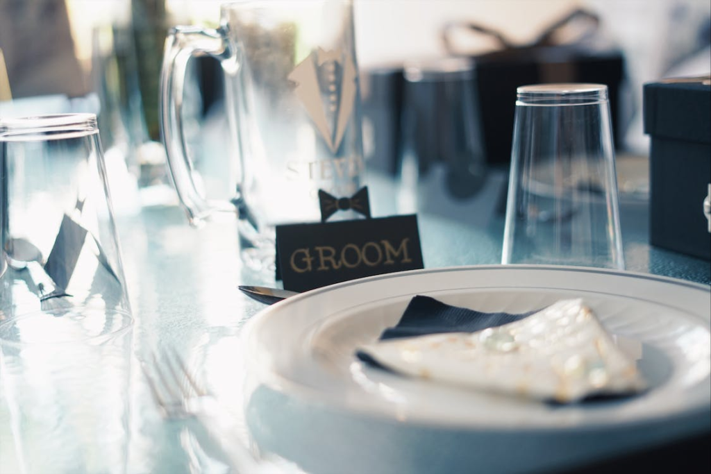 a table setting with groom glass