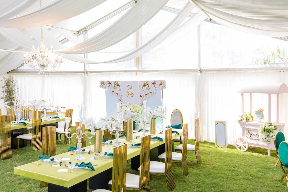 Tables, chairs, and décor set up under a white canopy